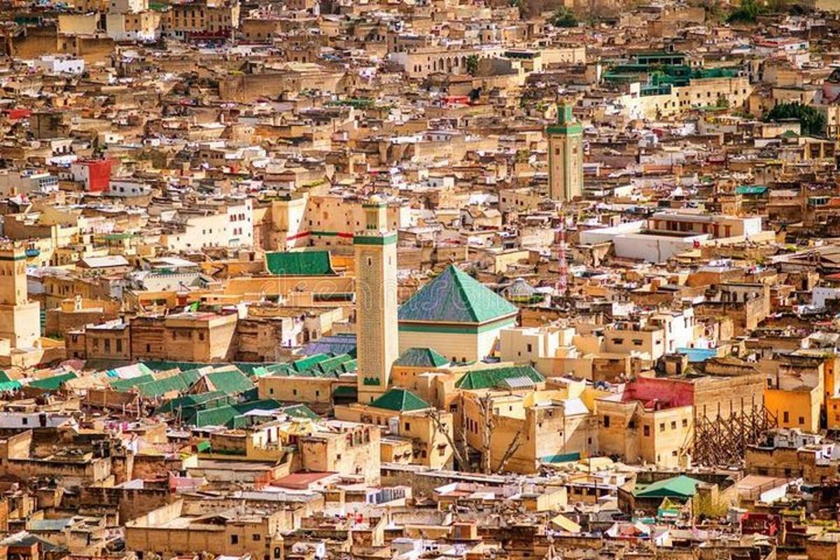 an aerial view of a city with a mosque