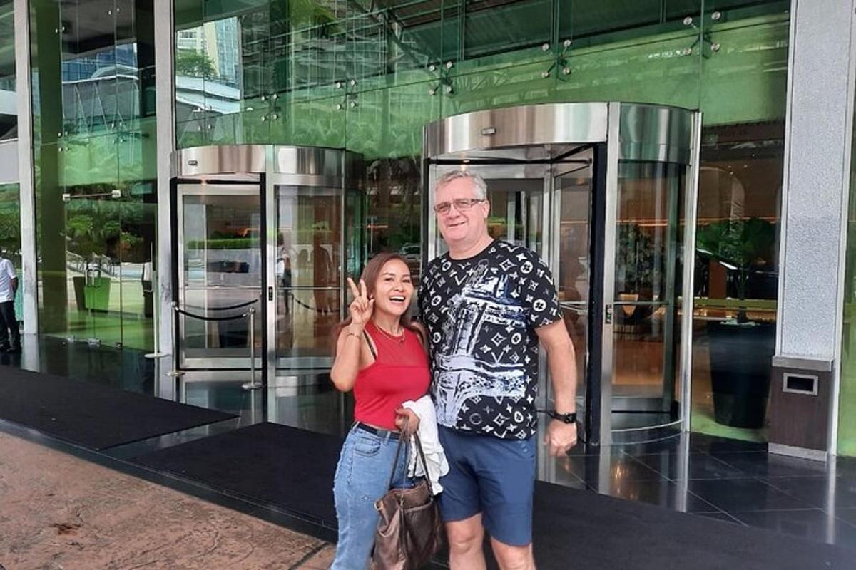 a man and a woman standing in front of a building