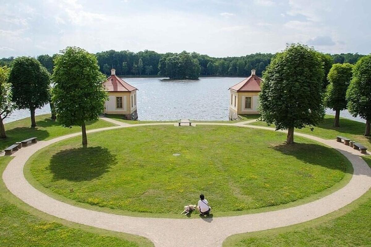 una persona amb un gos en un parc amb un llac