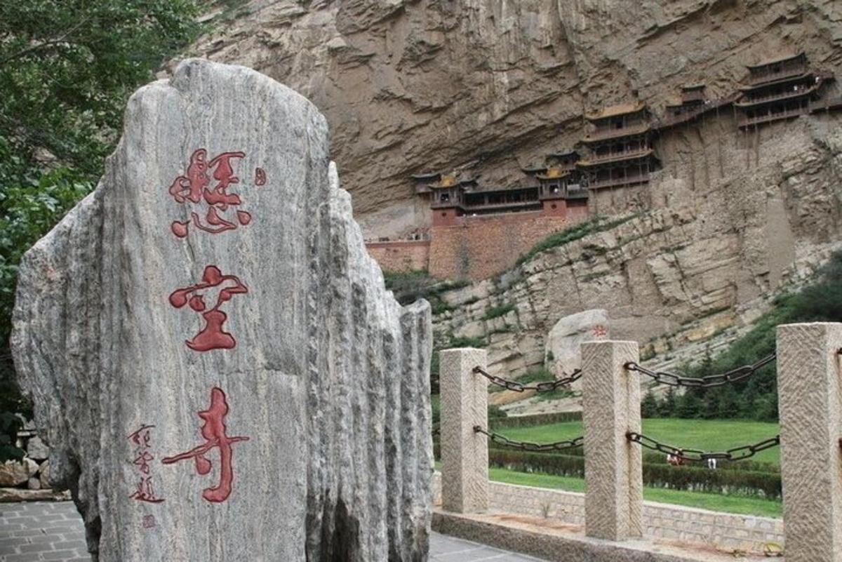 a rock with writing on it in front of a mountain