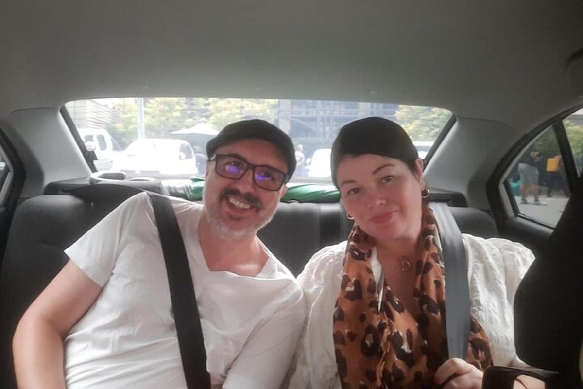 a man and a woman sitting in a car