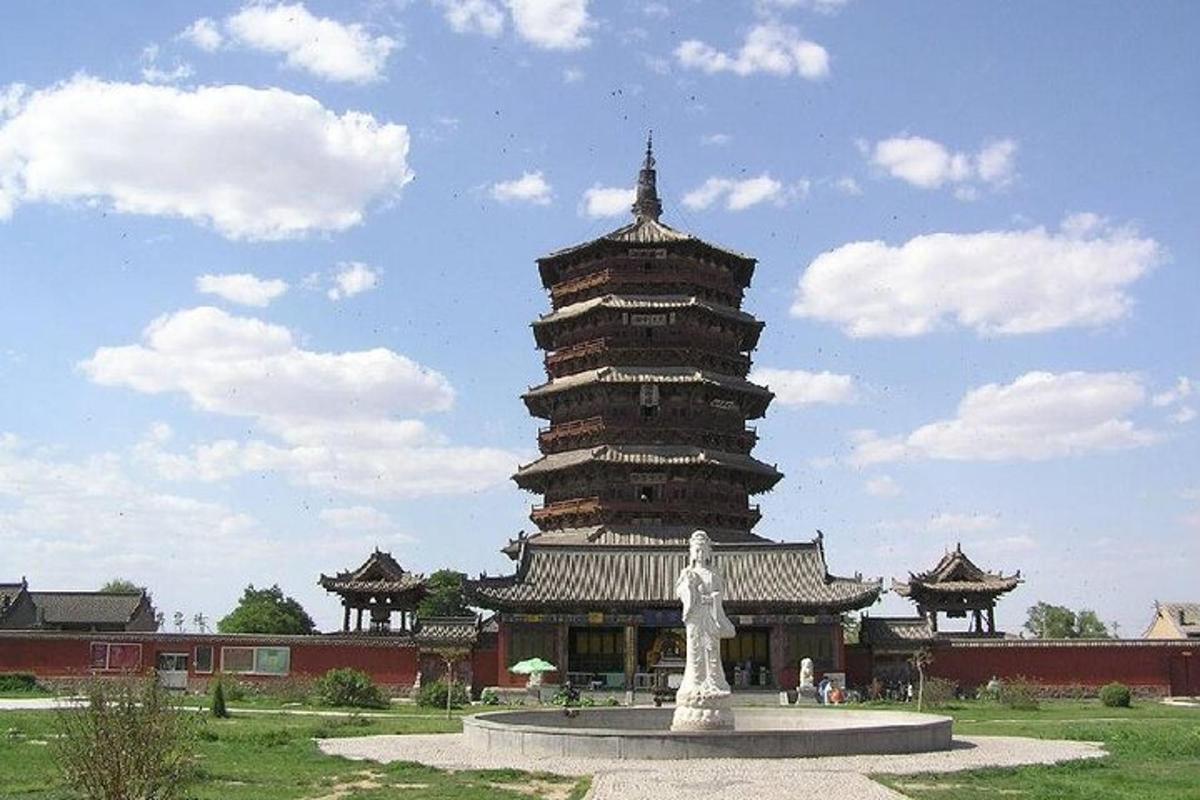 a large building with a statue in front of it