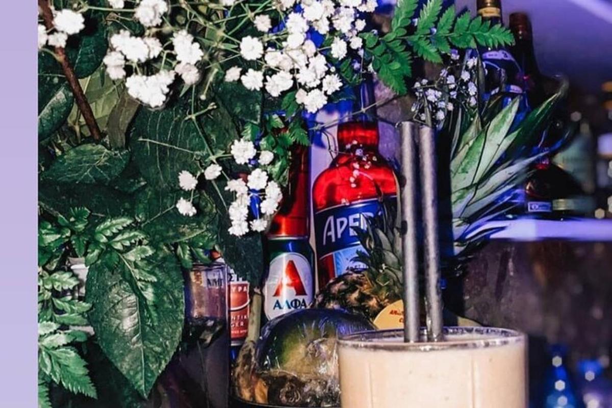 un grup d'ampolles d'alcohol i flors en un gerro