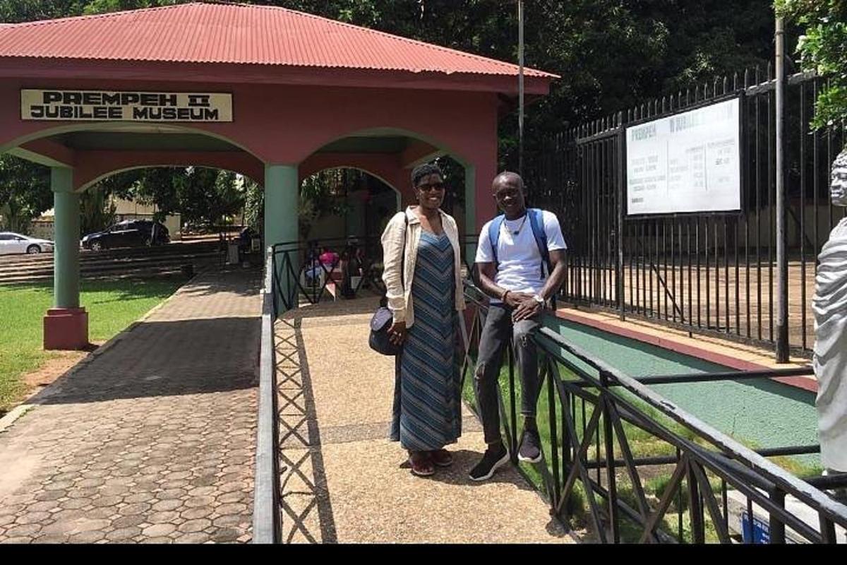 a man and a woman standing next to a fence