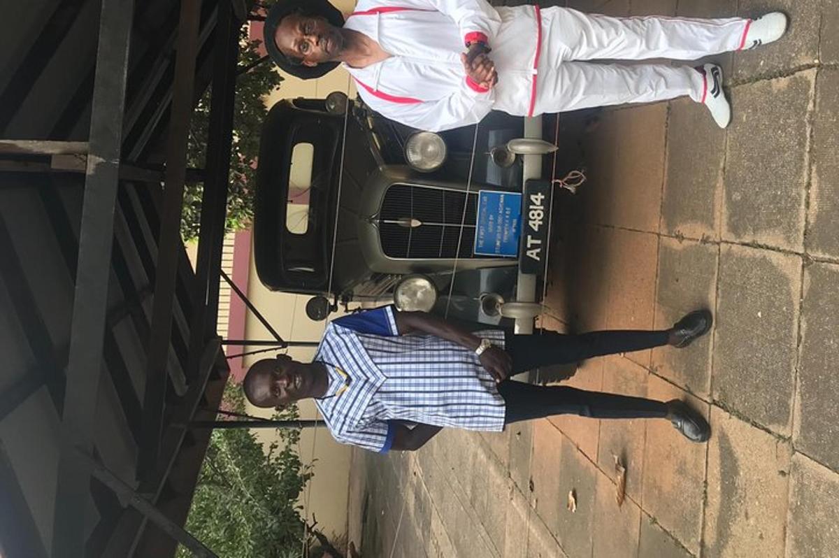 two men are standing next to a wall