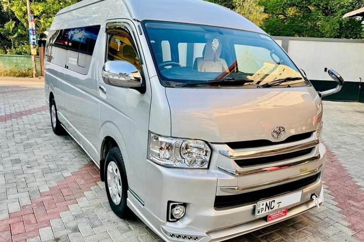 a silver van parked on a brick street
