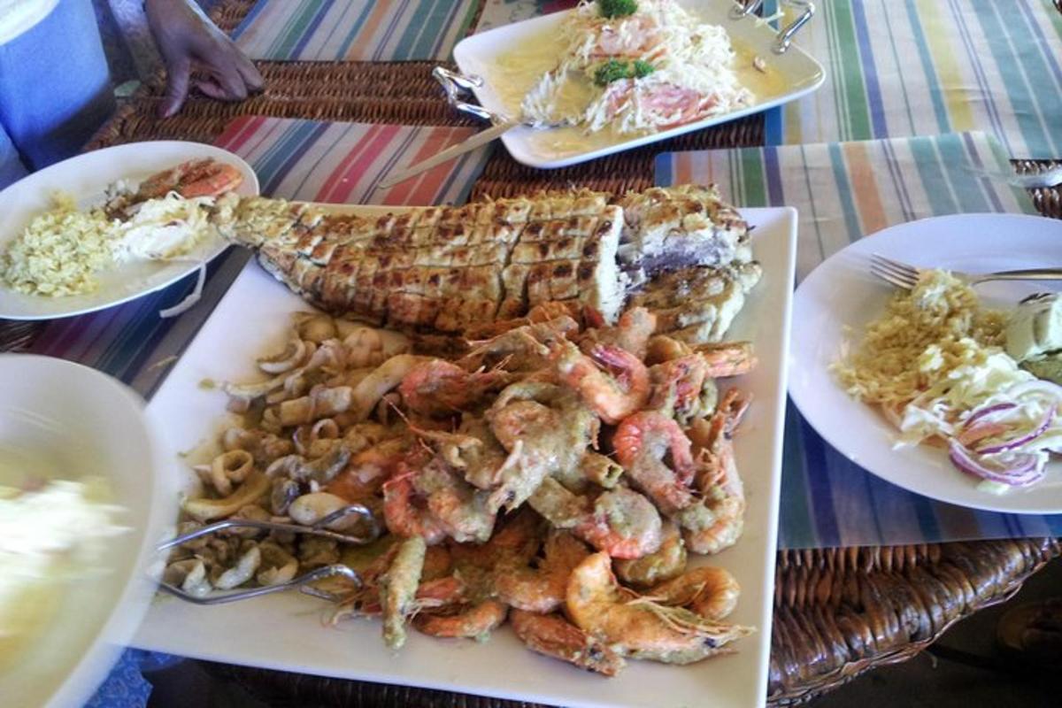 a plate of food with shrimp and other foods on a table