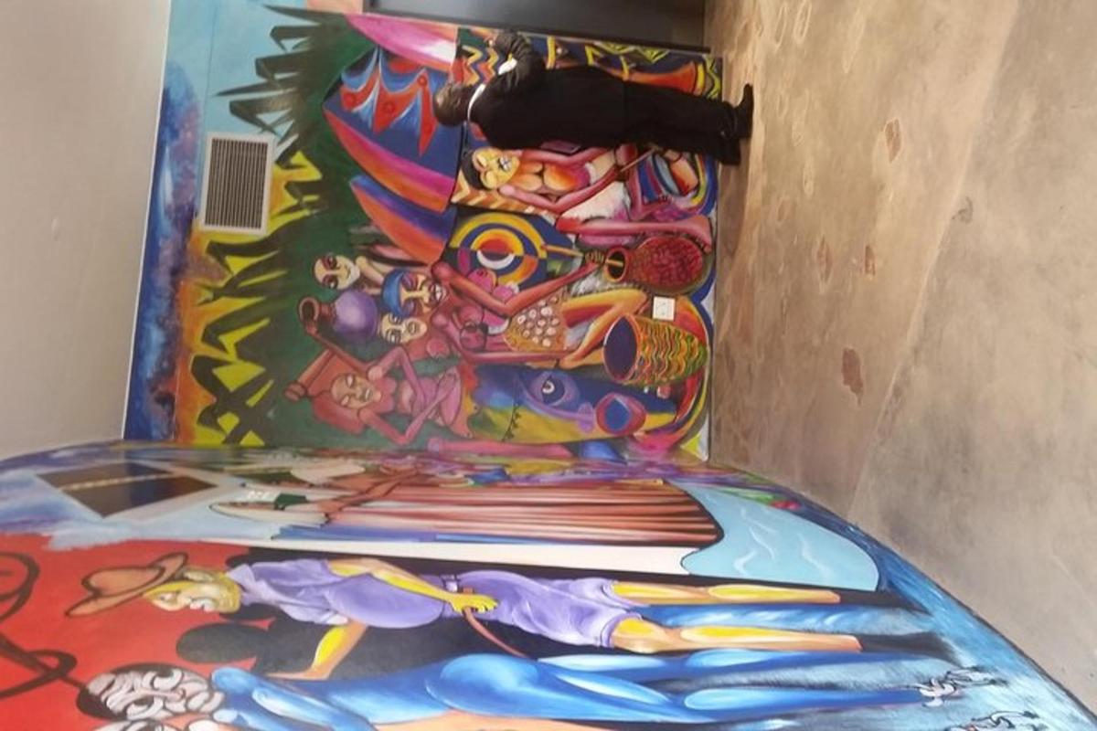 a pile of surfboards on the floor with a painting