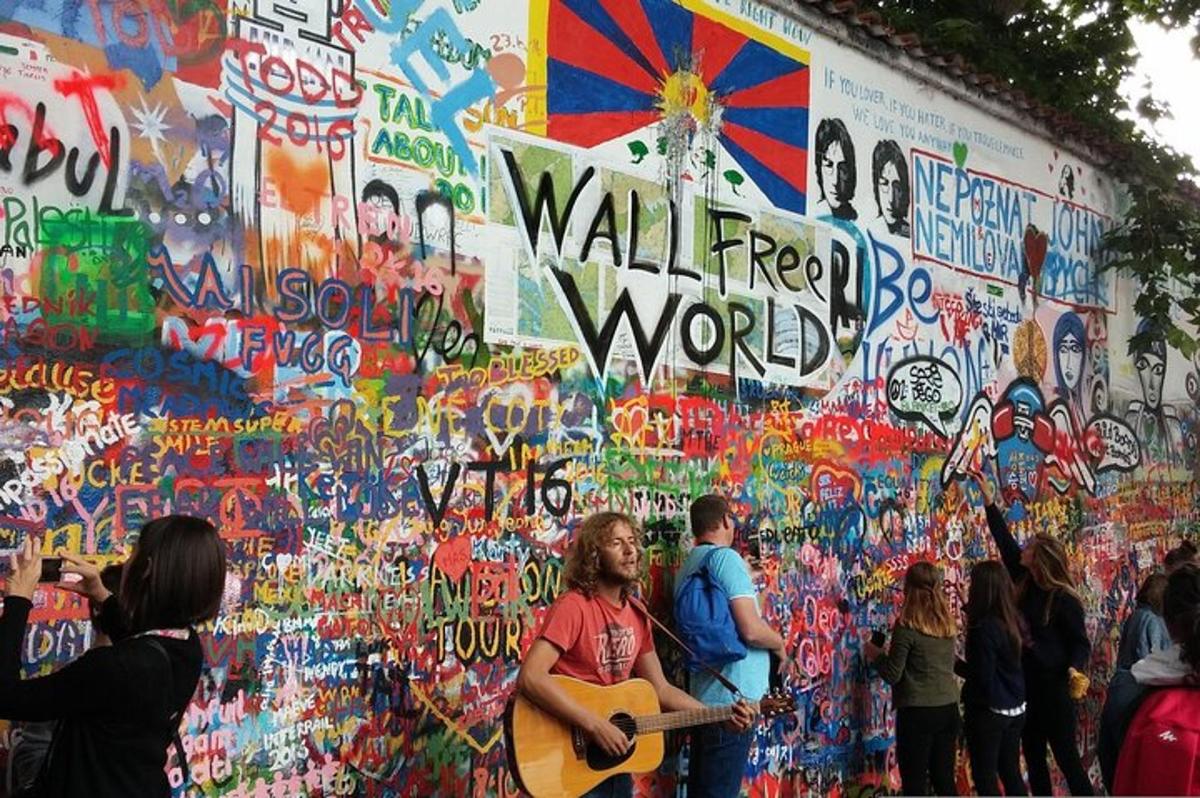 a group of people standing in front of a wall covered in graffiti