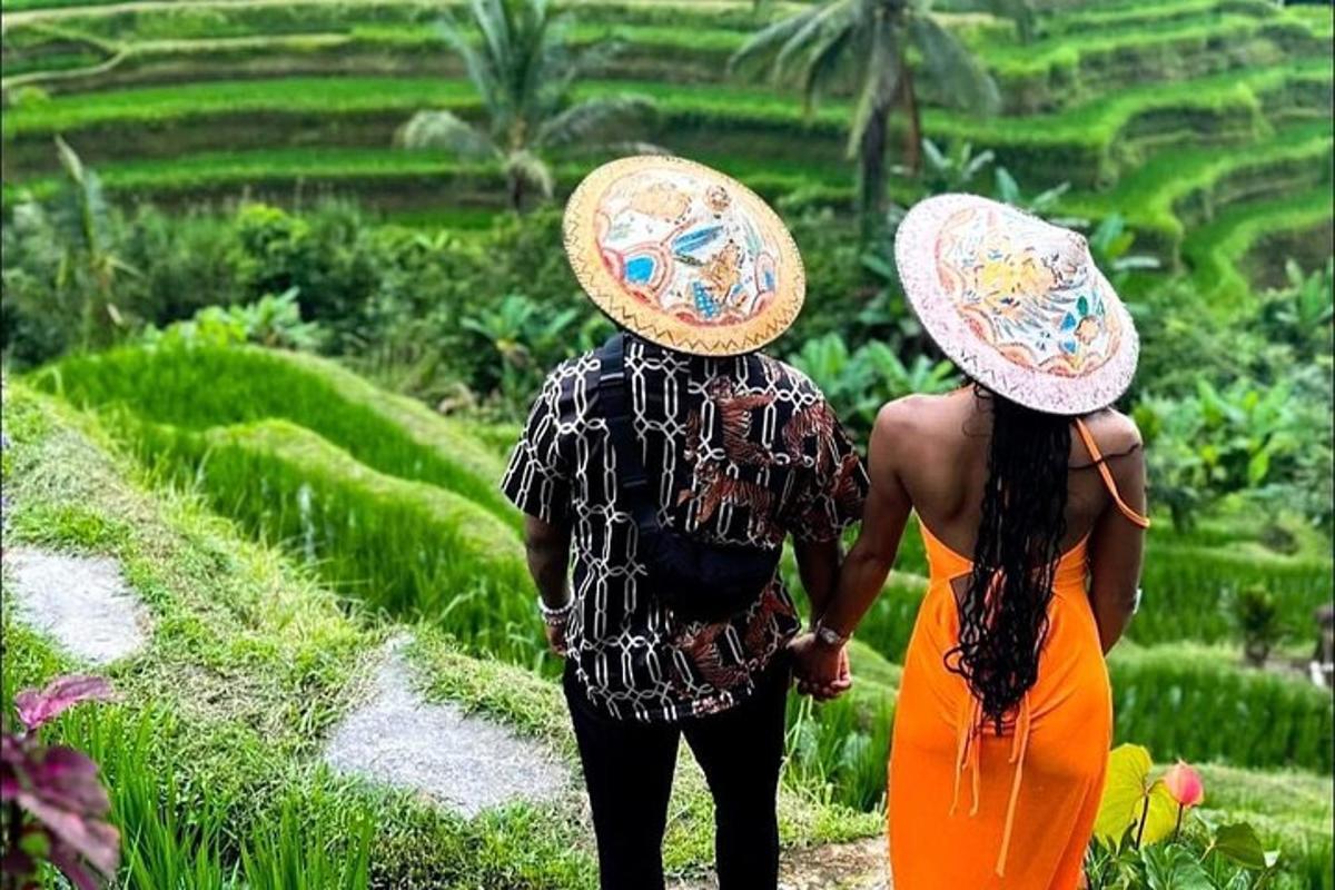 Dos mujeres con sombreros caminando por un campo de arroz