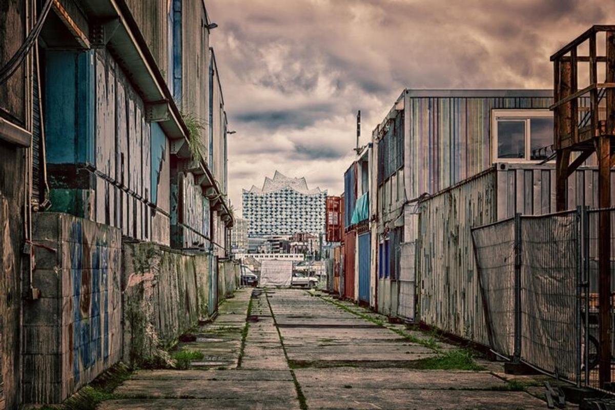 an empty alley with a city in the background