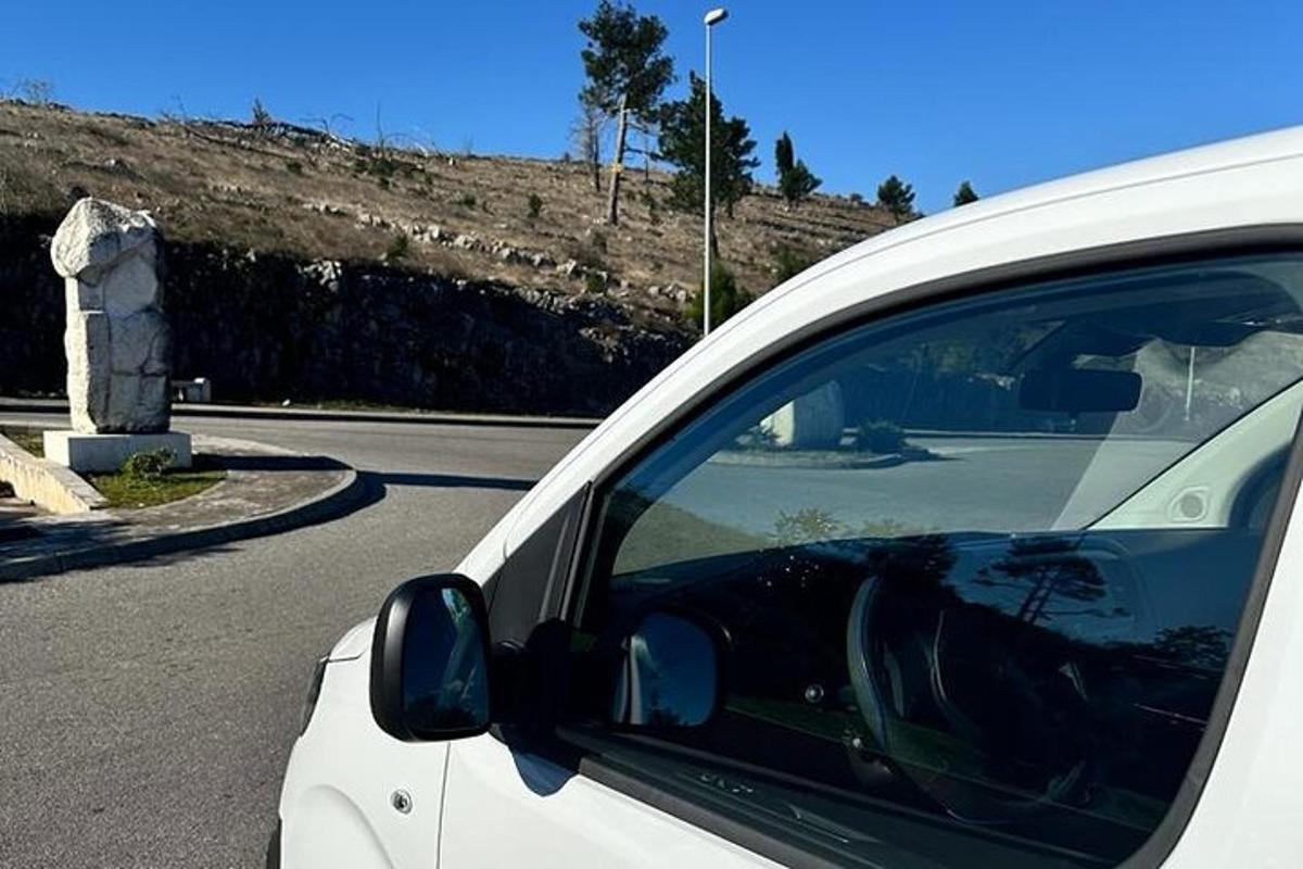 bílé auto zaparkované na kraji silnice