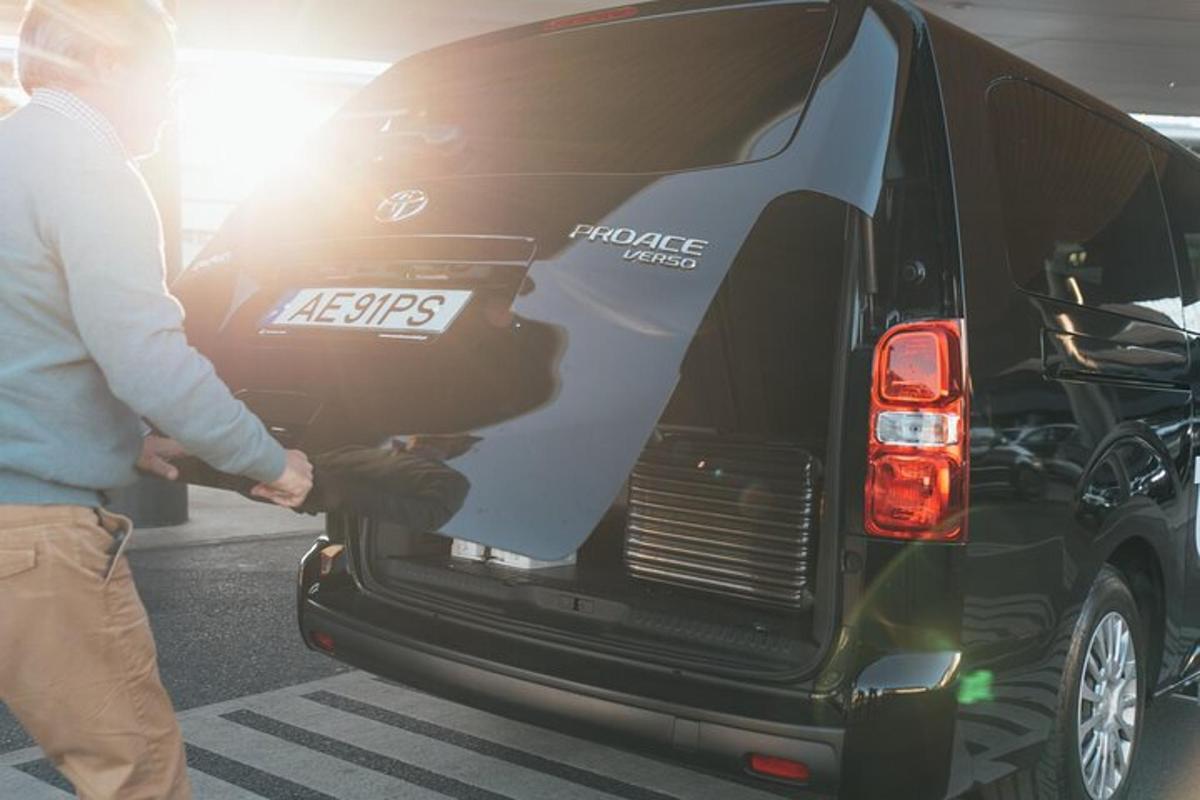 a man is unlocking the back of a black van