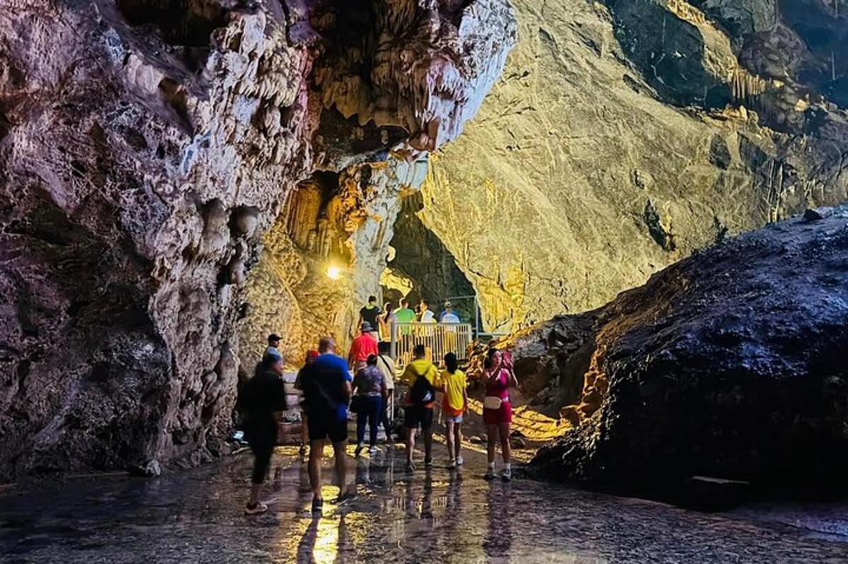 a group of people walking through a cave