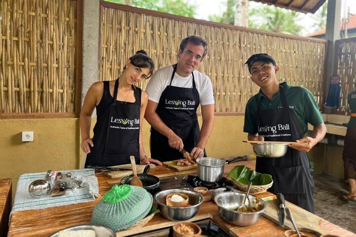 un grup de tres persones a la cuina preparant menjar