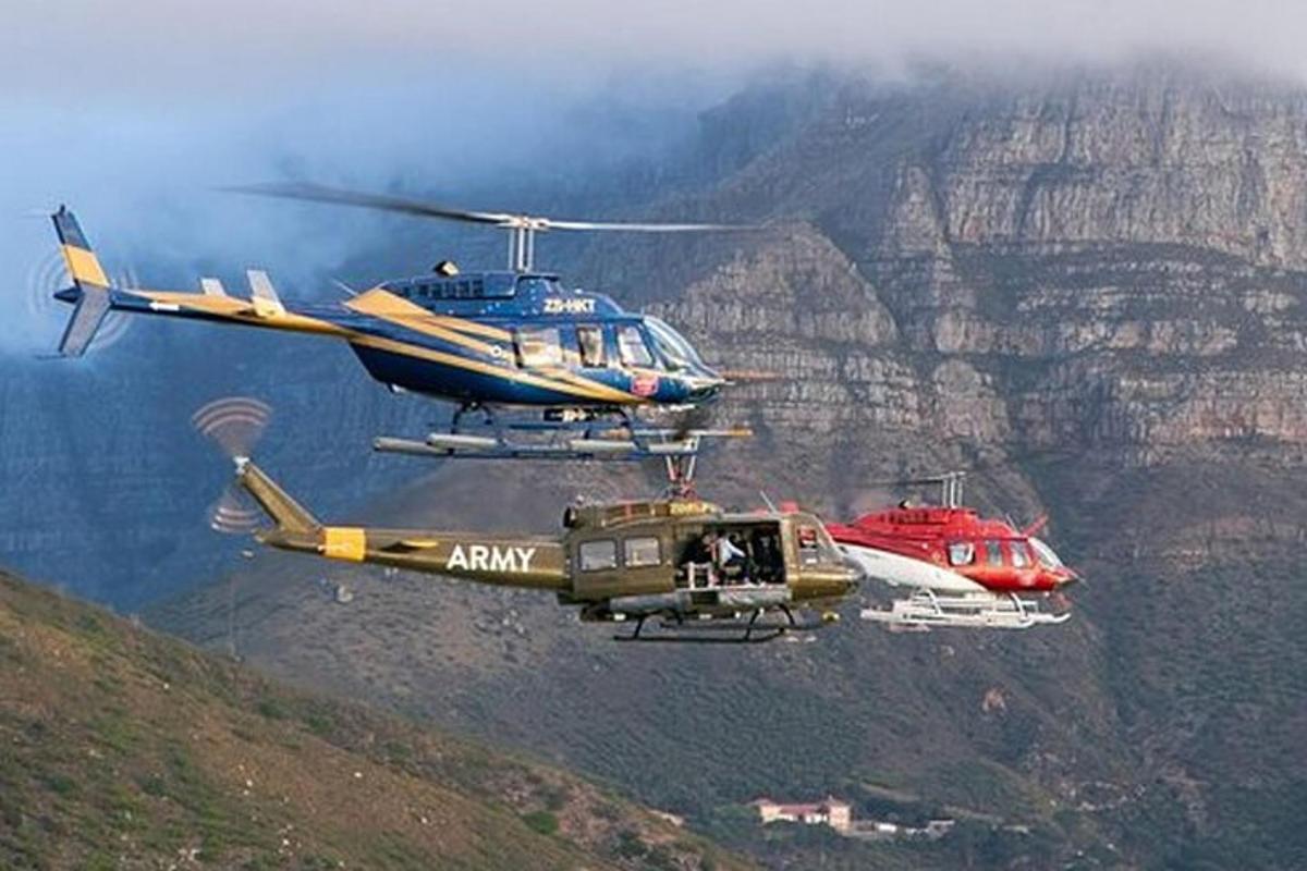 two helicopters are flying over the grand canyon
