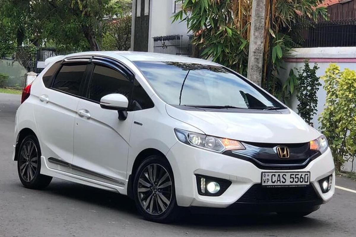a white car parked on the side of a street