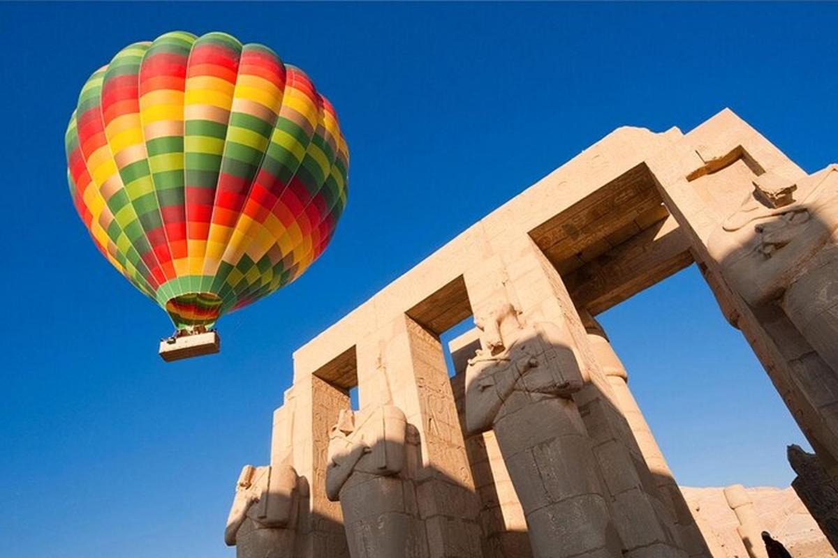a colorful hot air balloon flying over a building