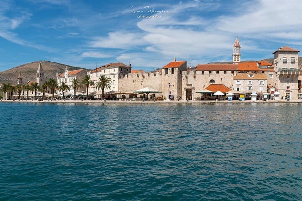 a group of buildings on the shore of a body of water