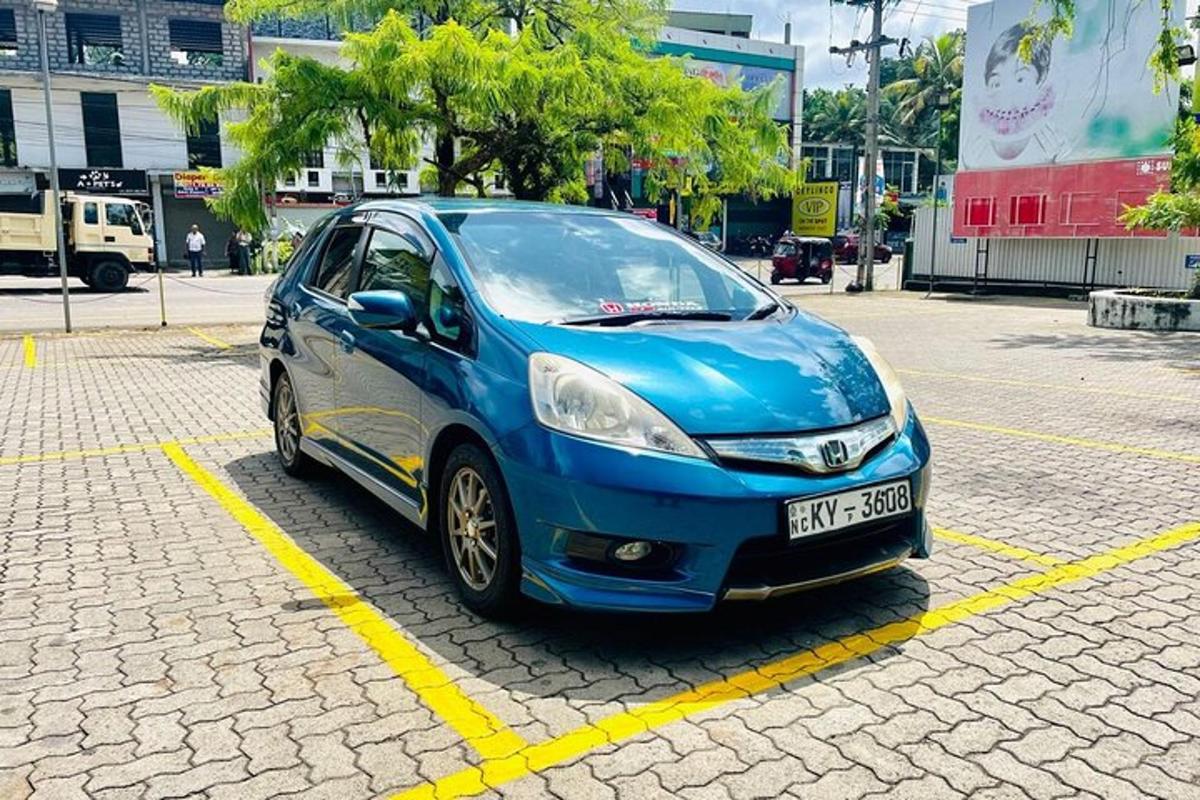 a blue car parked in a parking lot