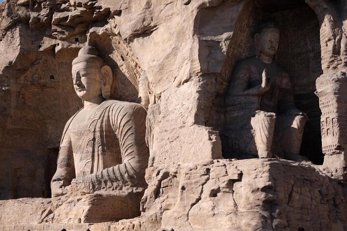 a statue of a man standing next to another statue