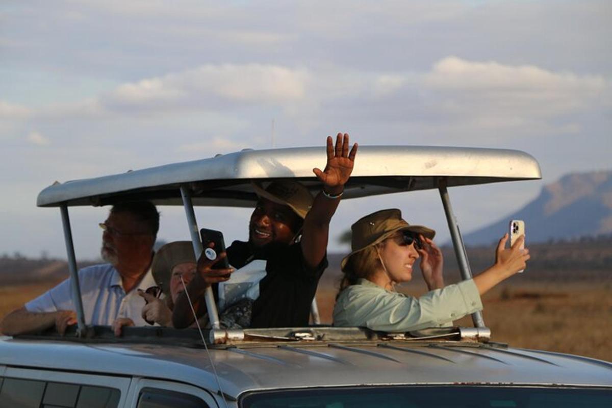 a group of people in a car taking pictures with their cell phones
