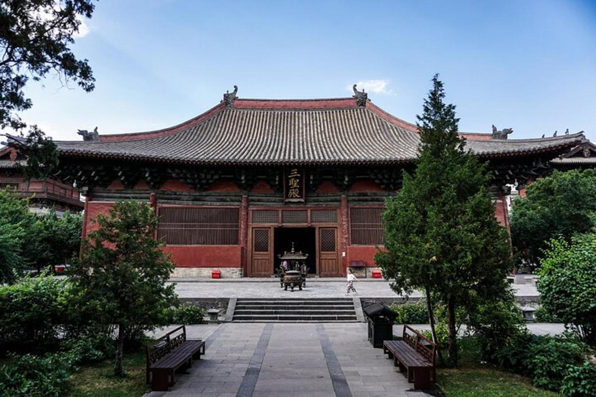 a large building with benches in front of it