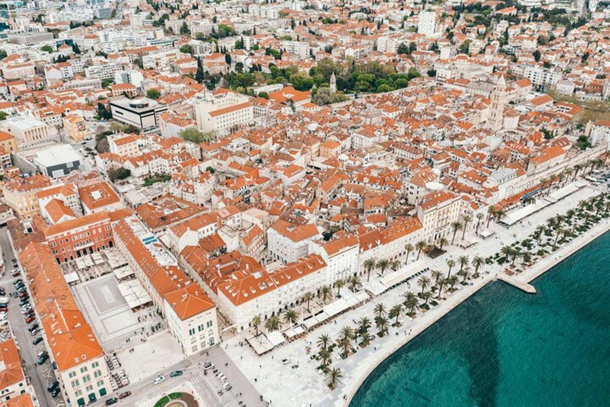 an aerial view of a city with buildings and the water