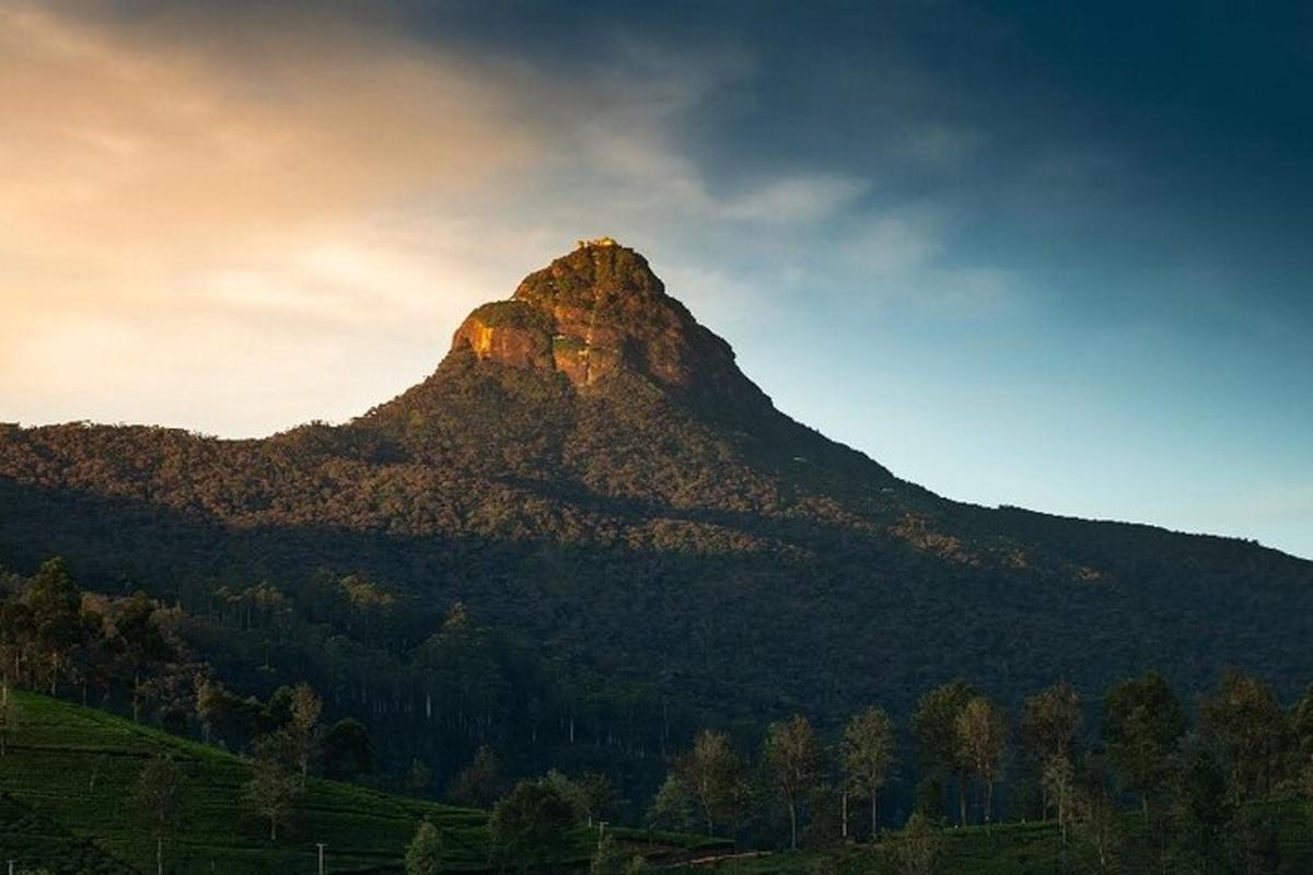 a mountain with the sun setting on top of it