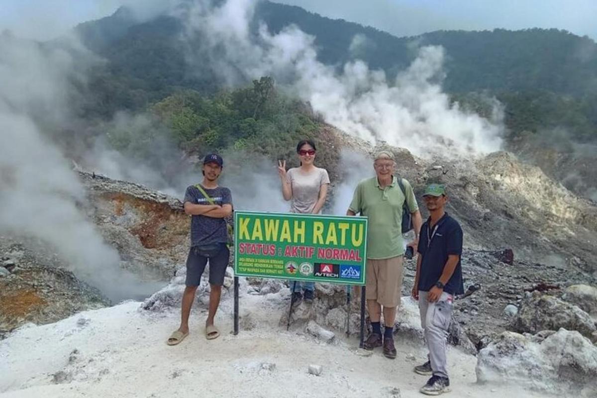 a group of people standing next to a sign