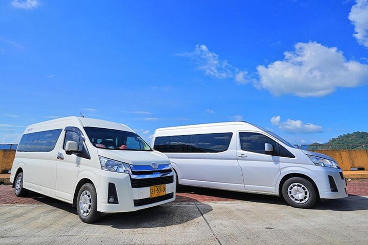 two white vans parked next to each other