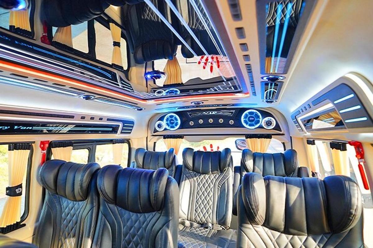 a bus with seats and a tv on the ceiling