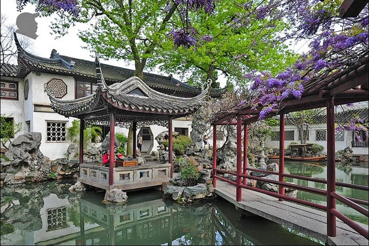 a house with a gazebo next to a pond