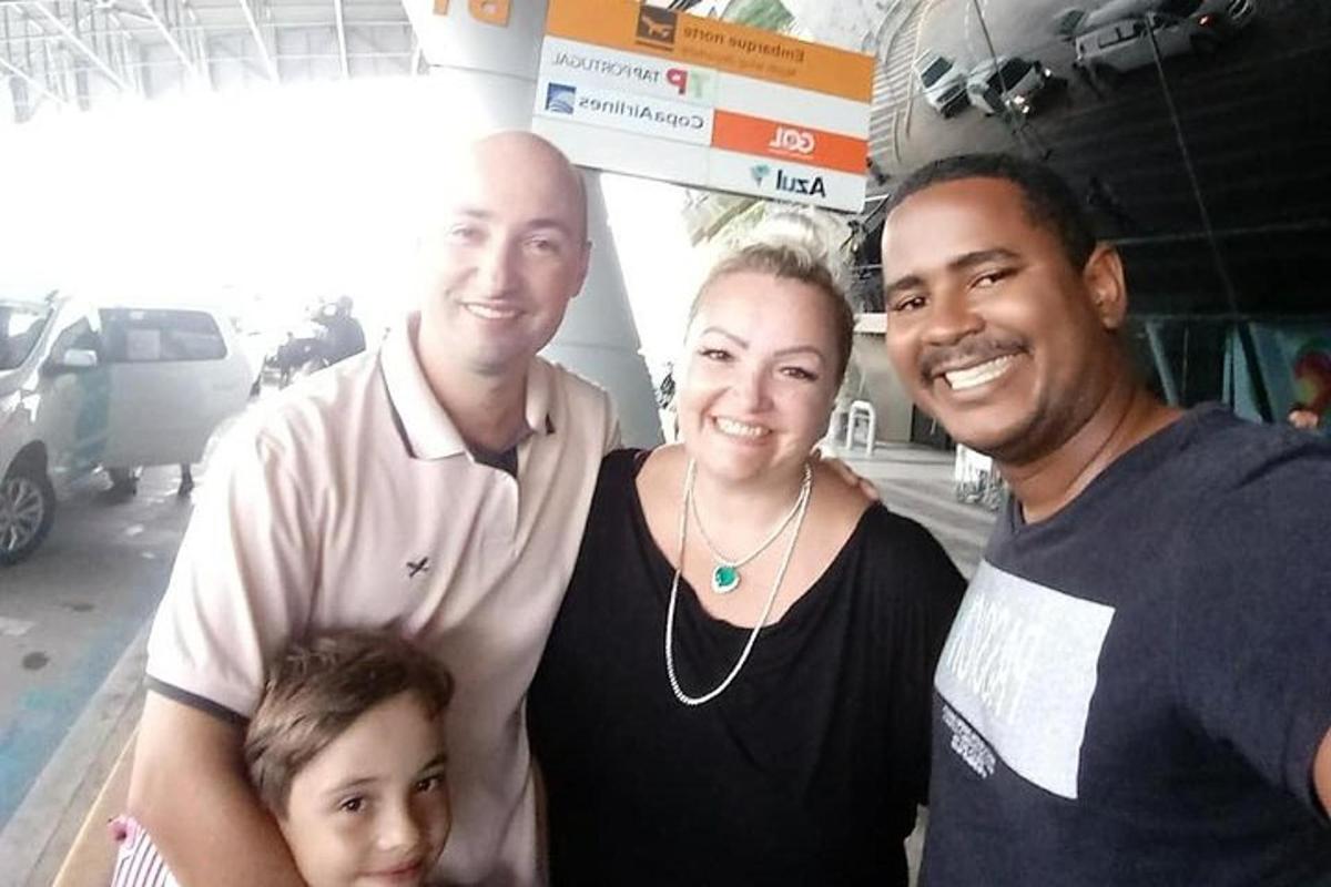a family posing for a picture at a gas station