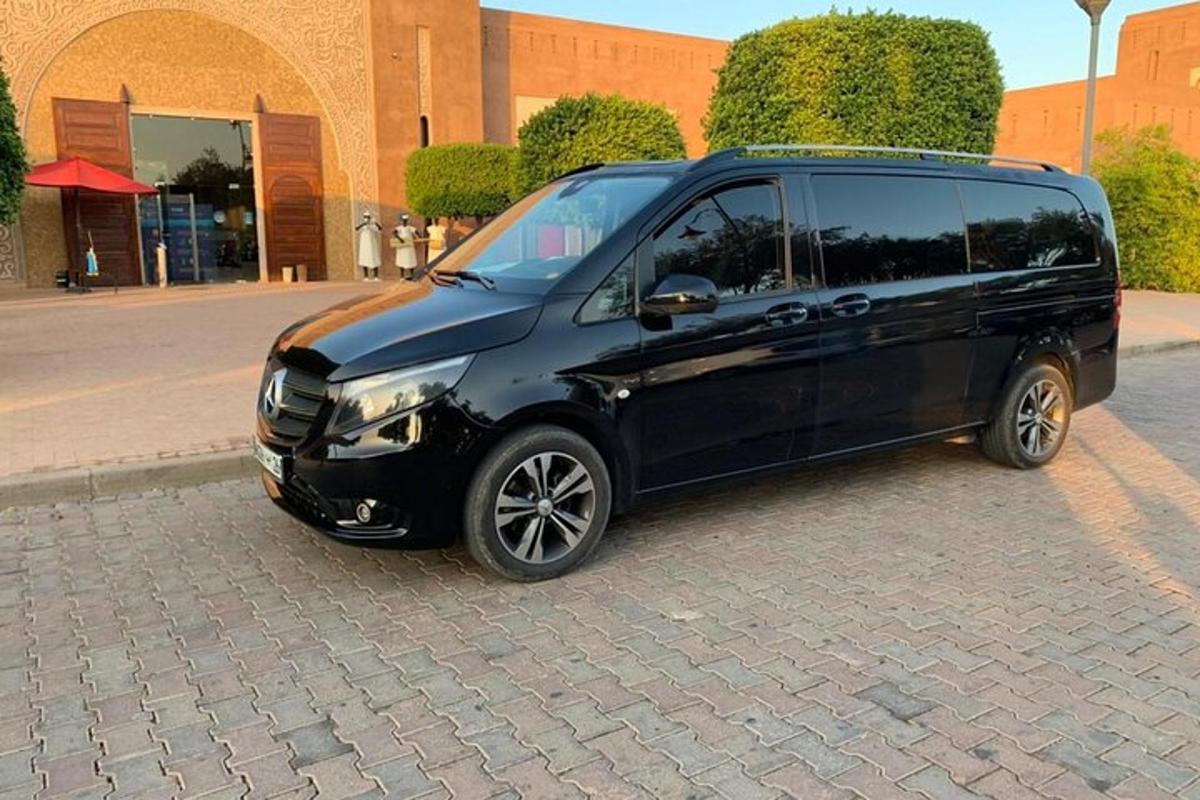 a black minivan parked on a brick street
