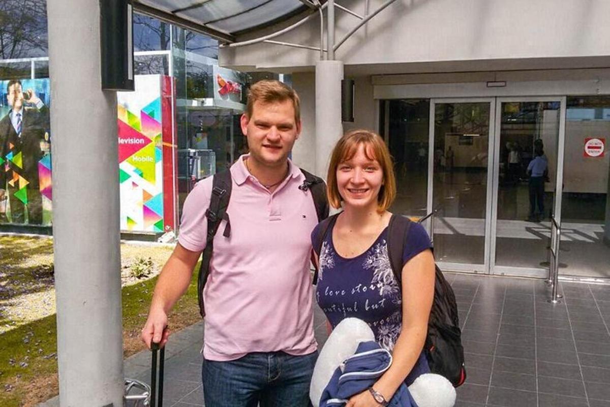 a man and a woman standing in front of a building