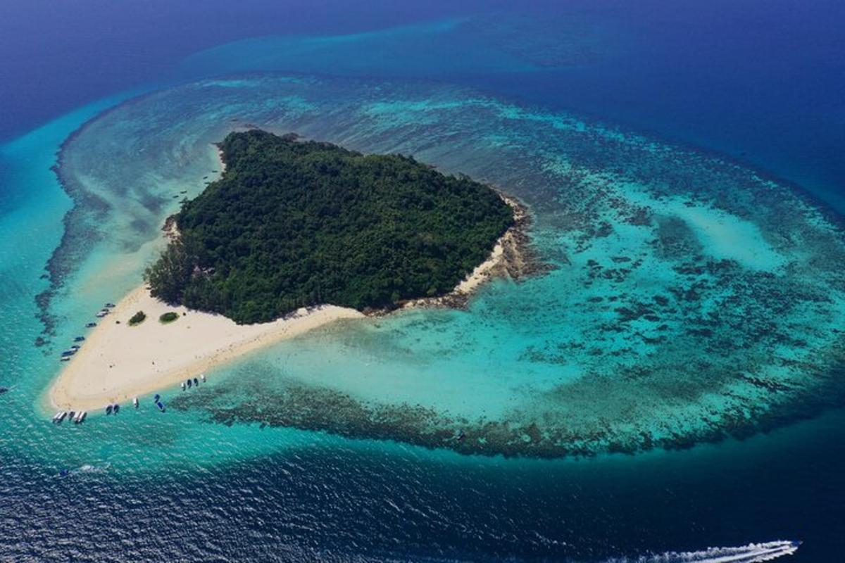 an island in the ocean with people on a beach