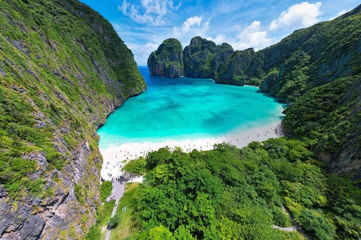 an aerial view of a beach between two mountains