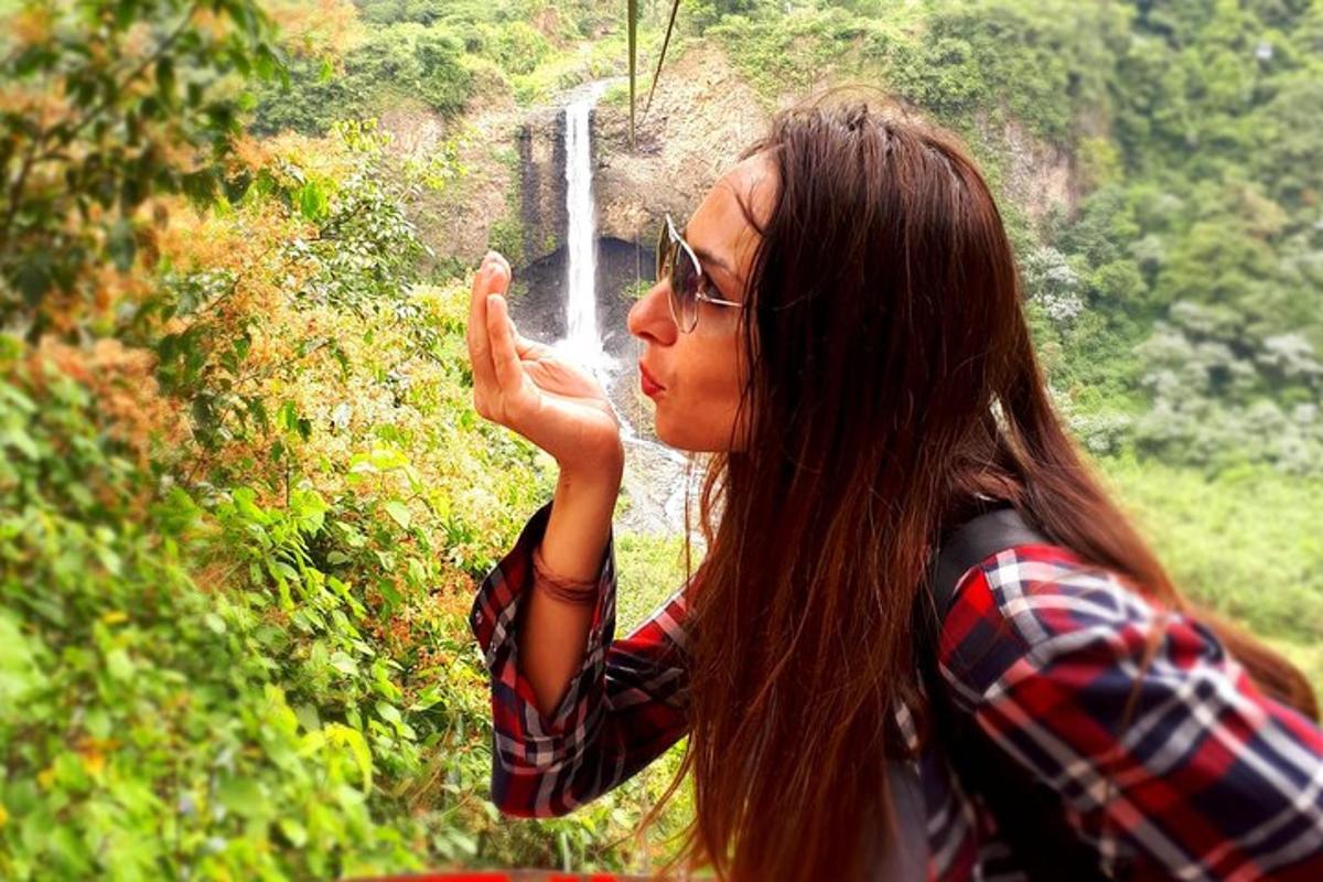 a woman standing in front of a water fountain
