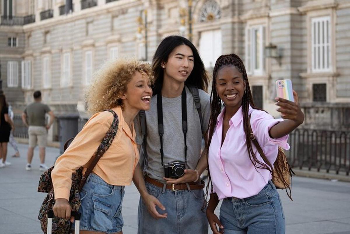 three women standing next to each other with a cell phone