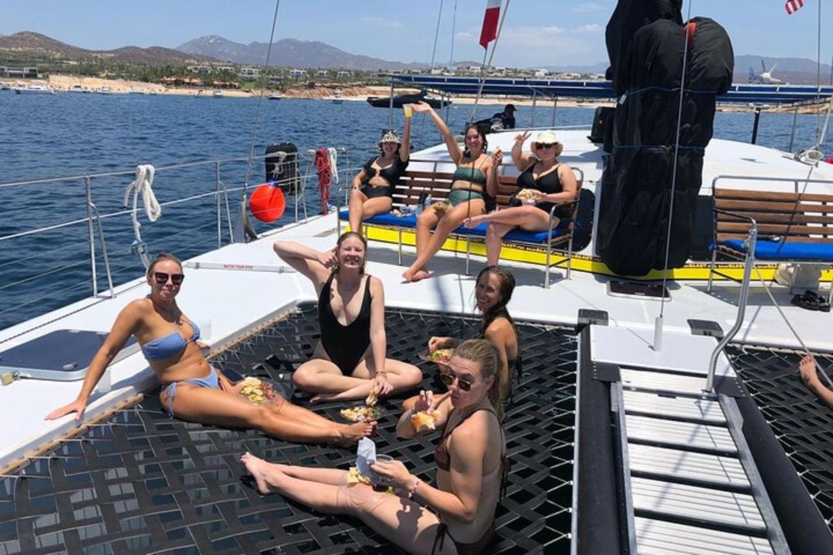 a group of women sitting on the deck of a boat