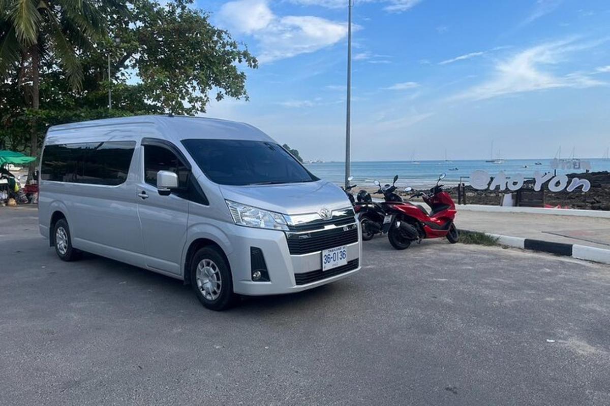 a van parked in a parking lot next to a motorcycle