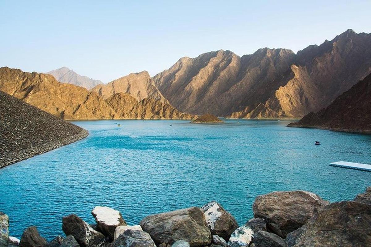 a large body of water with mountains in the background