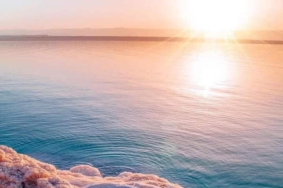 a view of the ocean with the sun reflecting on the water