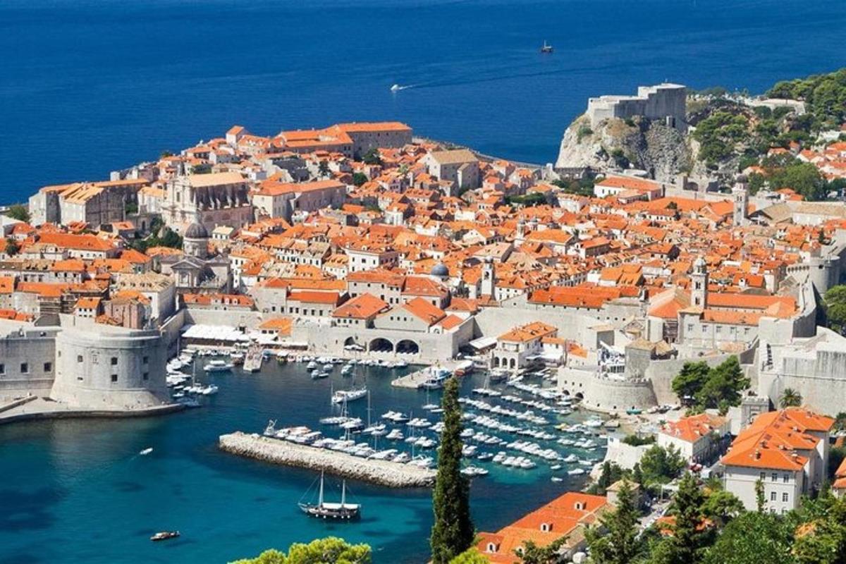 an aerial view of a city with boats in the water