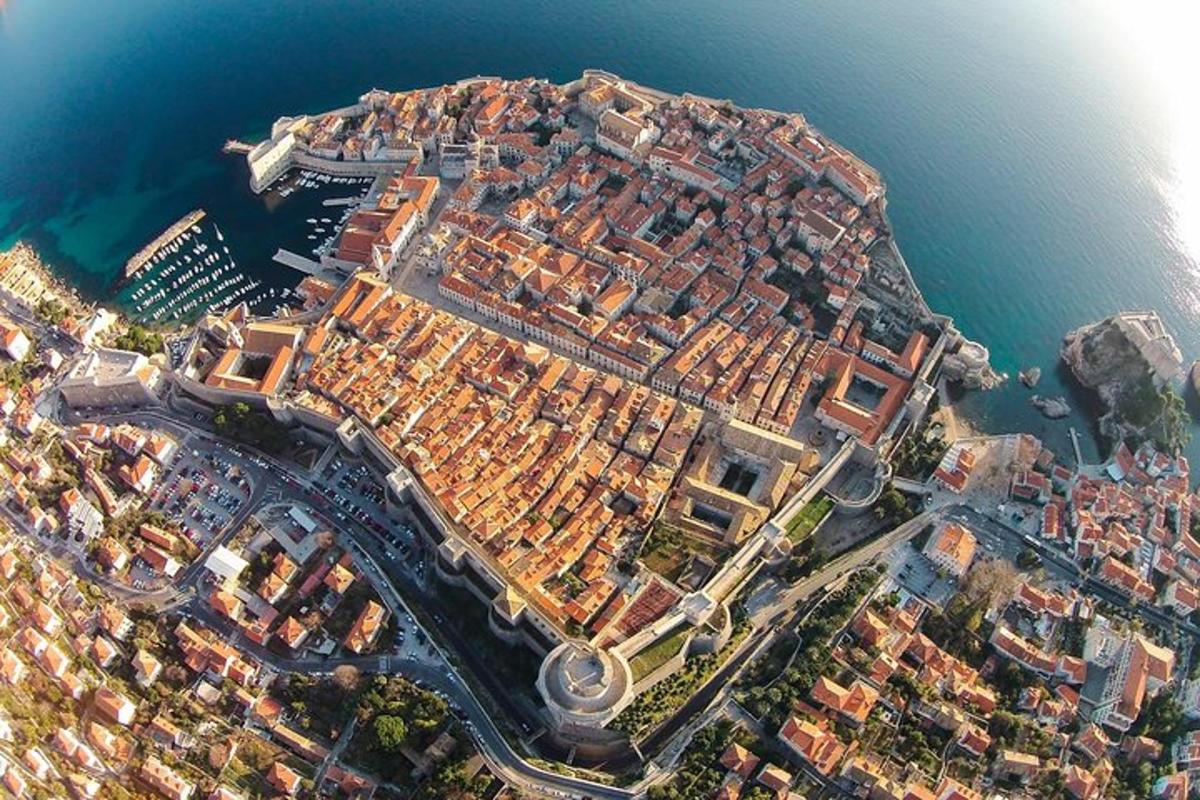 an aerial view of a city next to the water