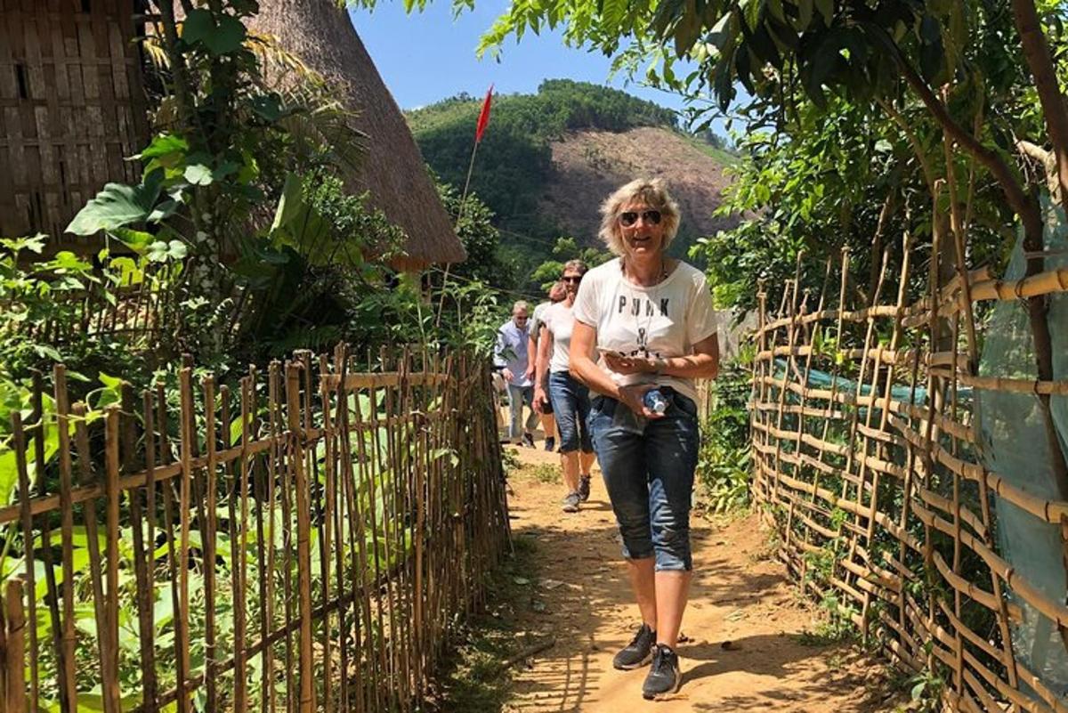a woman walking along a fence on a trail