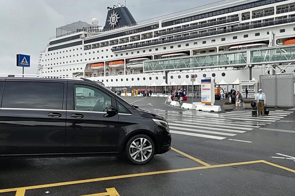 un furgone nero parcheggiato davanti a una nave da crociera