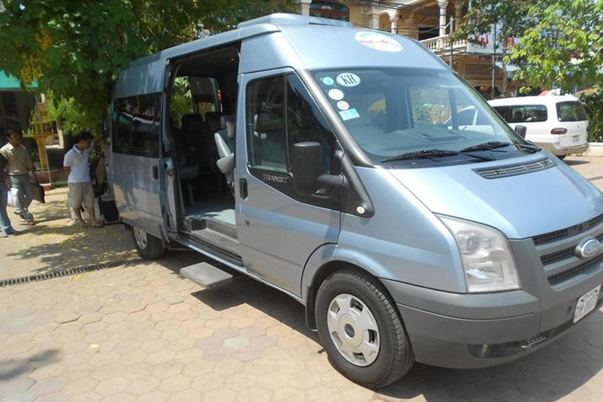 một chiếc xe tải nhỏ màu xanh với cánh cửa mở trên phố