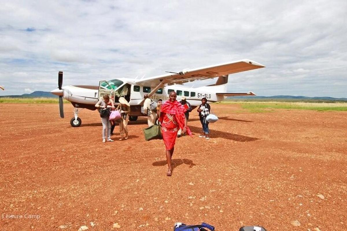 a group of people walking towards a small plane